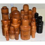 Approximately twenty-one turned wooden medicine bottle holders, including some ebonised examples.