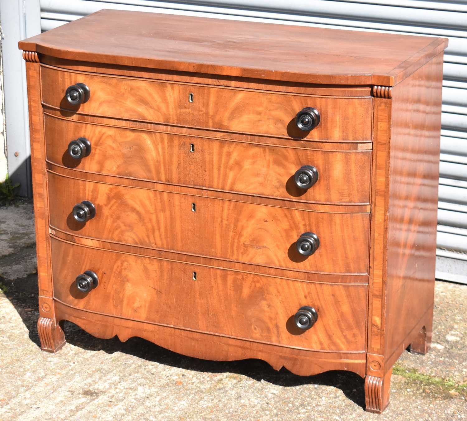 A 19th century mahogany bowfronted chest of four long drawers on bracket feet, width 95cm.