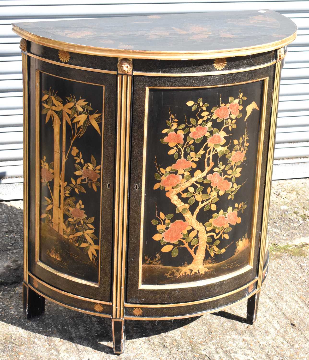 A reproduction black lacquer and gilt chinoiserie decorated demi-lune cabinet, width 88cm, depth