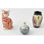 ROYAL CROWN DERBY; a cat paperweight with gold stopper, a small Moorcroft vase with impressed mark