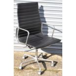 A modern chrome framed Eames Vitra style revolving office chair.