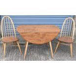 ERCOL; a mid century light oak drop-leaf dining table with four matching spindle back chairs,