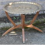 A brass top folding table
