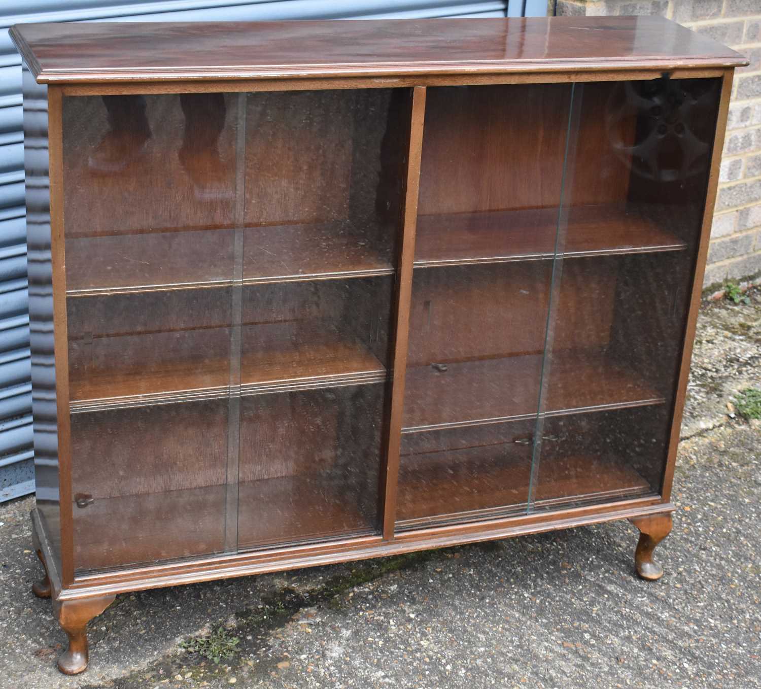 A 20th century mahogany display cabinet with pair of glazed sliding doors, width 117cm.