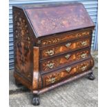 An early 19th century mahogany and Dutch marquetry inlaid bureau, the fall front enclosing a