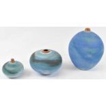 Three studio pottery bulbous vases decorated in a powder blue glaze, each with impressed marks,