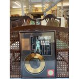 An Elvis Presley commemorative gold record/disc 'In the Ghetto', framed with Elvis image and