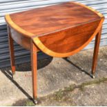 A 19th century mahogany and satinwood crossbanded oval Pembroke table with two end drawers on square