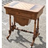 A walnut crossbanded and inlaid fold over games table with chess board top, on castors, height 74cm,