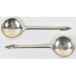 RALPH SAMUEL; a pair of Edward VII hallmarked silver apostle soup spoons, London 1902, 3ozt/95g.