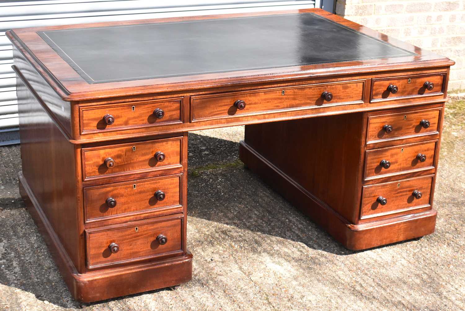 A good Victorian mahogany partner's desk of typical form, the primary side fitted with nine drawers,