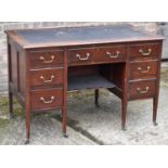 An Edwardian mahogany seven drawer knee-hole desk, width 123cm.