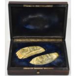 A rare pair of early 19th century scrimshawed whale's teeth, both carved with galleons to the