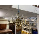 An eighteen branch brass chandelier, 58cms drop and approximately 85cms diameter.