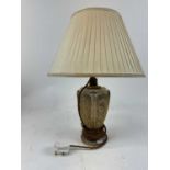 A gilt decorated glass table lamp with scrolling gilt metal overlay, height approx 22cm.