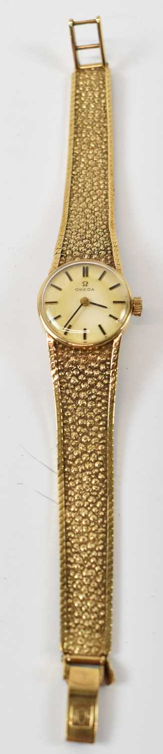 OMEGA; a 9ct yellow gold lady's wristwatch with bracelet strap.