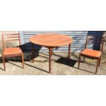 A teak circular dining table, diameter 112cm, and a set of four chairs (5).