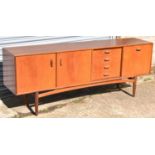 G PLAN; a teak sideboard with two cupboard doors, four drawers and one fall front cupboard door,