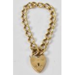 A 9ct yellow gold heart shaped padlock on 18ct yellow gold chain, approx 27.2g.