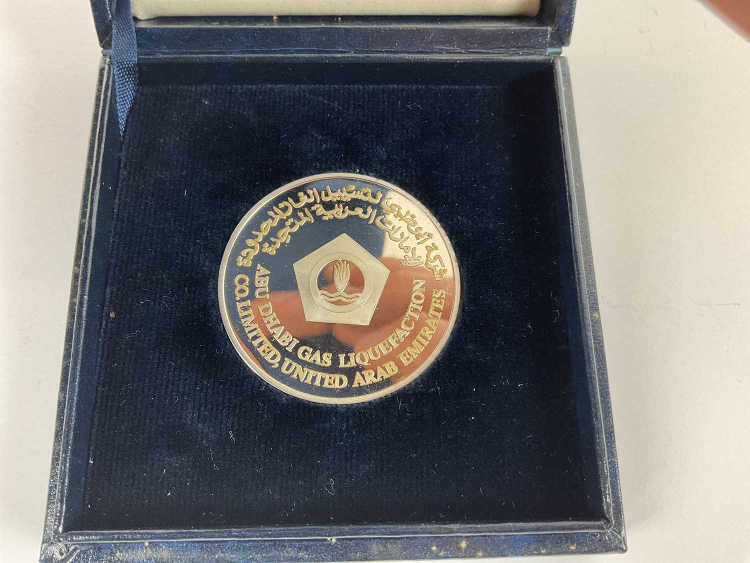 A cased Abu Dhabi Gas Liquefaction100th LNG Cargo to Japan 1980 silver coin. - Image 2 of 3