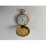 A 14ct yellow lady's gold pocket watch, 3 cms diameter.