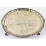 A George V hallmarked silver salver with presentation inscription, rubbed marks, diameter 26cm, 23.