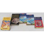 A group of five Harry Potter books including The Philosopher's Stone, The Chamber of Secrets, The