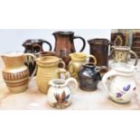 Twelve assorted studio pottery jugs, height of tallest 19cm.
