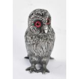 A Victorian hallmarked silver novelty pepper as an owl with glass eyes and pierced cover, London