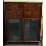 An early 19th century mahogany and ebony strung serving cabinet with six drawers above a pair of