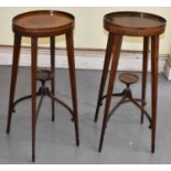 A pair of Edwardian mahogany oval stands (part af), height 74cm.