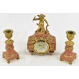 An early 20th century French pink marble and gilt metal mounted clock garniture, the central