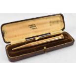 A 9ct gold 'The Mascot' propelling pencil, in case marked Baker's British Pencil, approx 21.8g.