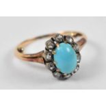 A yellow metal turquoise and diamond cluster ring, size F/G, approx 2.9g.