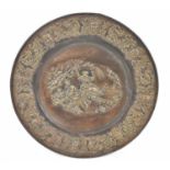 A large embossed brass tray, diameter 62.5cm.