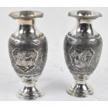 A pair of Persian Isfahan type white metal baluster form vases with engraved decoration, height