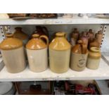 Five large stoneware flagons, one smaller, two stoneware vases, and seven stoneware bottles.