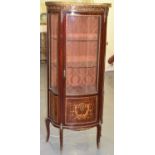 A French mahogany kingwood veneered and inlaid bowfronted vitrine with gilt metal mounts, glass