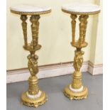 A pair of large decorative gilt brass stands with marble tops, diameter 38cm, height 97cm.