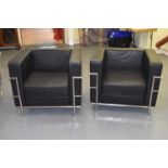 A pair of stylish contemporary chrome framed black leather enclosed armchairs.Condition Report:
