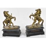 A pair of late 19th century French brass and black slate models of Marly horses, height 27.5cm.