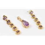 A 14ct yellow gold pendant set with large purple stones and three small white stones approx 2.5g,