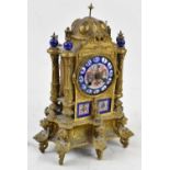 A 19th century French gilt metal and porcelain mounted Gothic-inspired mantel clock with Roman