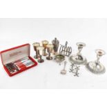 A small quantity of silver plated items including pair of candlesticks, three goblets, toast rack,