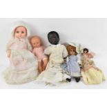 Five assorted vintage dolls.