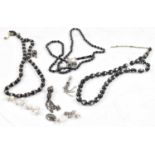 Three hardstone islamic bead necklaces with various white metal pendants and parts, etc.