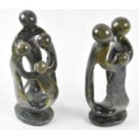 Two green hardstone carvings representing a family of three and a family of four, height 26cm.