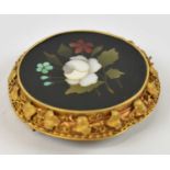 An Italian Pietra Dura floral brooch set in ornate yellow metal frame, approx 13g.