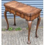 An 18th century walnut card table, with crossbanded top above frieze drawer on cabriole single