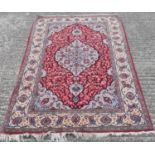 A large Persian red ground carpet, 207 x 52cm.